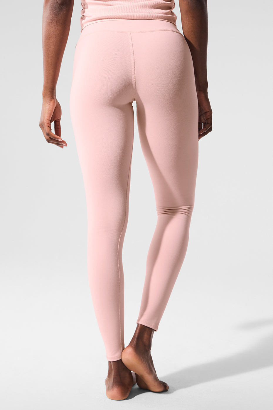 Side profile of s& s activewear leggings worn during yoga on a rooftop