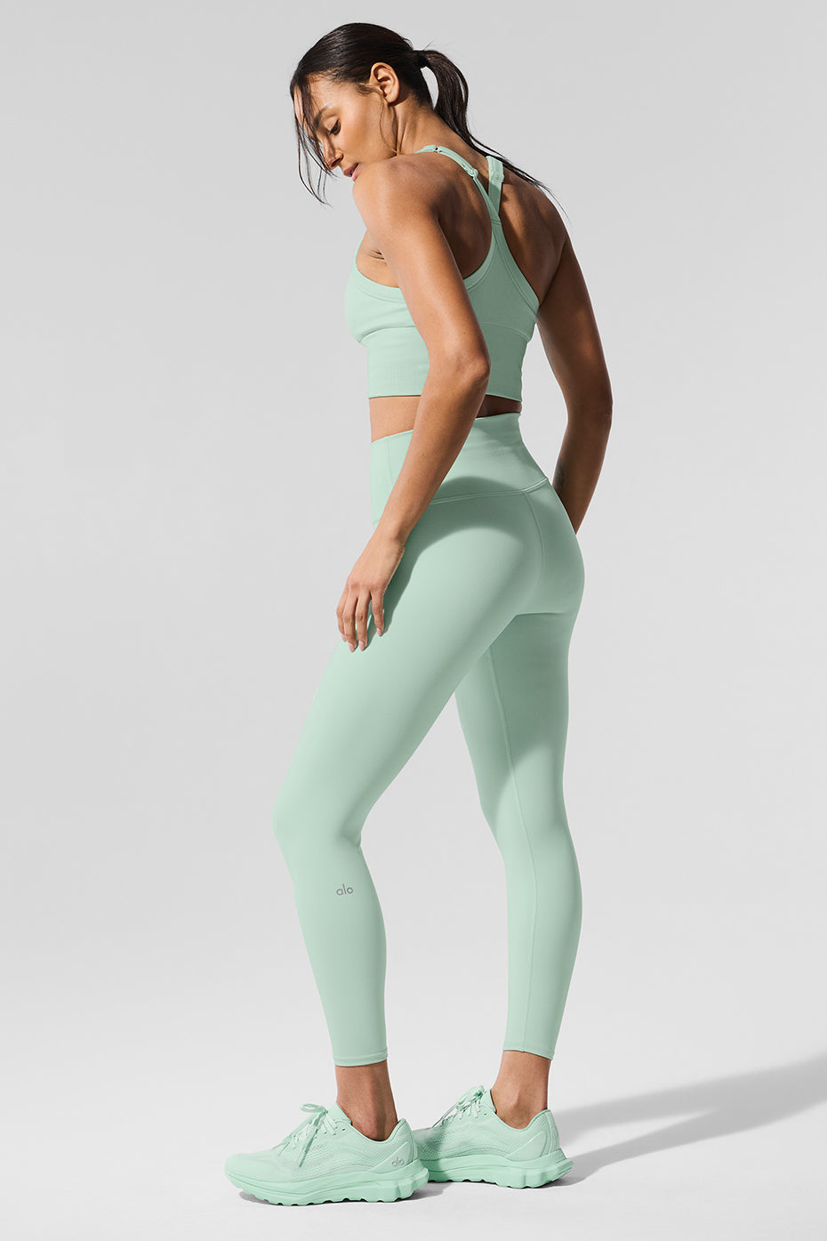 Model wearing spearmint high waisted leggings against a downtown Knoxville backdrop