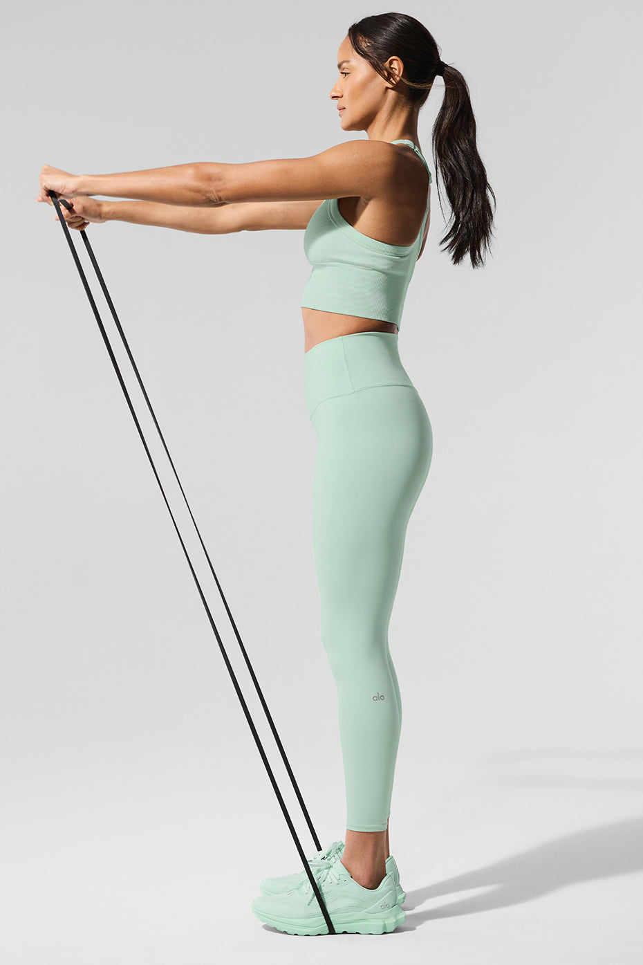 Model wearing spearmint high waisted leggings against a downtown Knoxville backdrop