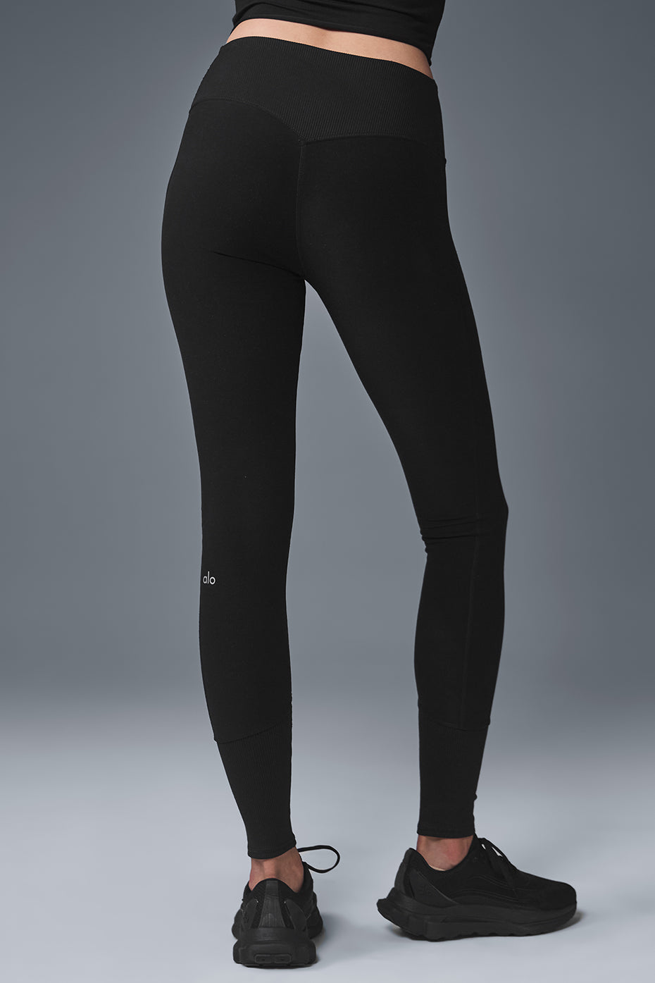 Back view of black high-waist leggings highlighting the contouring seam.