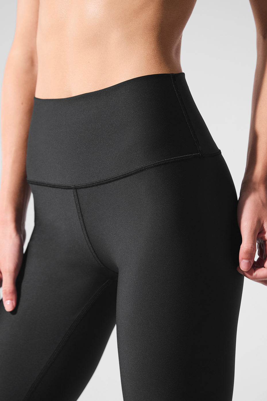 Front view of black high-waist Airlift leggings, showcasing the sculpting fit.