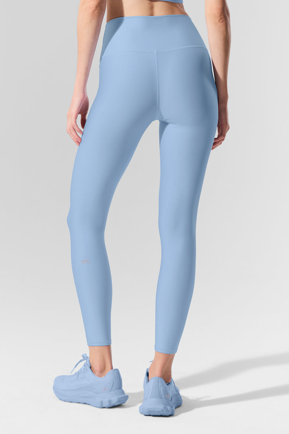 Side view of high-waist leggings, highlighting the double-layered waistband and sleek design.