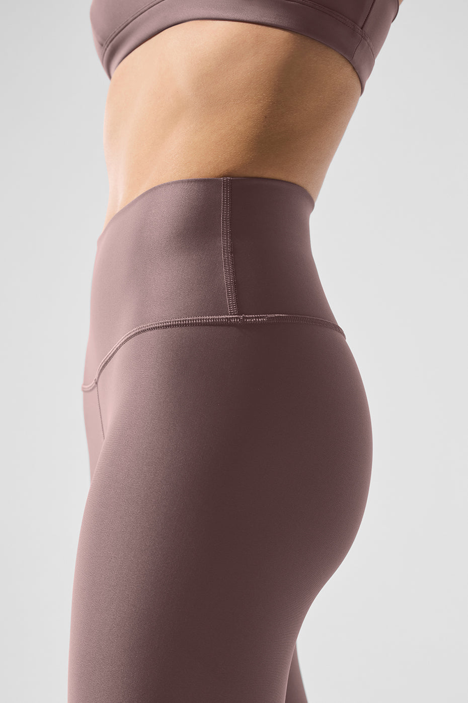 Side angle of model wearing mushroom 7/8 leggings outdoors