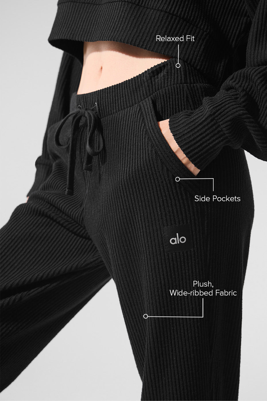 Close-up of high waist sweatpants fabric texture, folded on marble surface