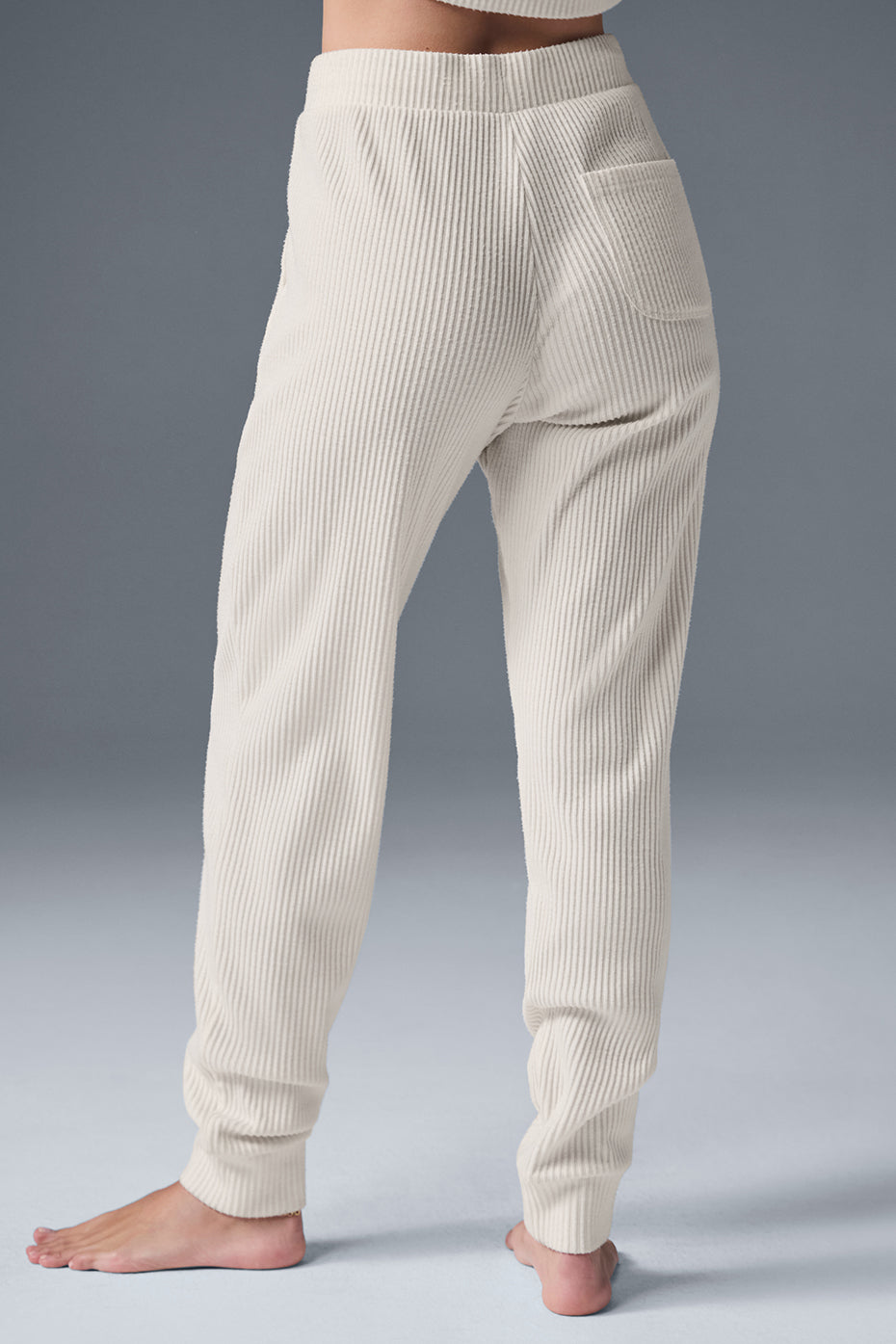 Side view of Muse sweatpants, highlighting the high-rise waistband and ankle cuffs.