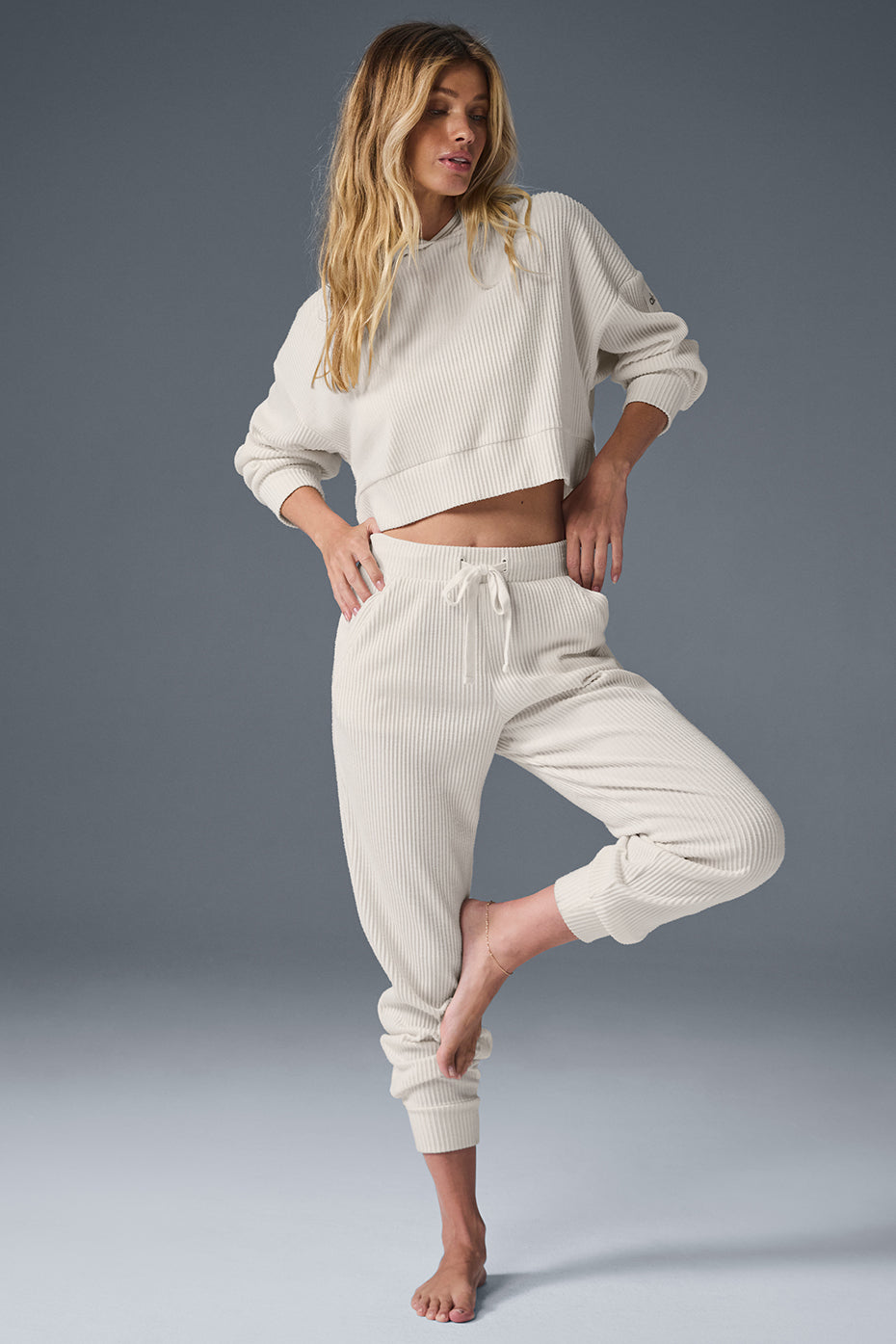 Side view of Muse sweatpants, highlighting the high-rise waistband and ankle cuffs.