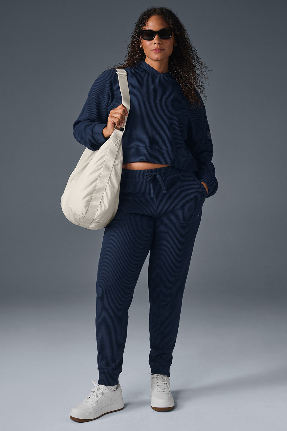Muse Navy Joggers folded on a wooden bench, showcasing texture
