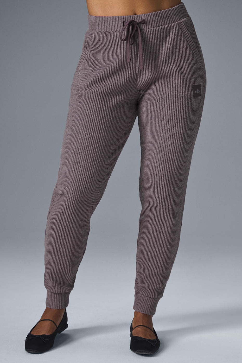 Side view of mens joggers styled with sneakers, showcasing ribbed fabric.