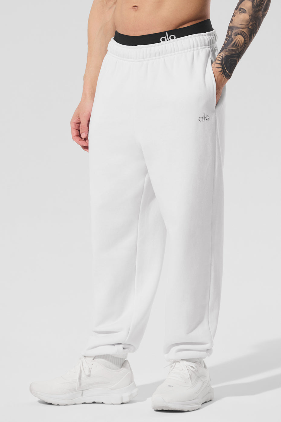 Close-up of white joggers with elastic waistband, perfect for mens loungewear.
