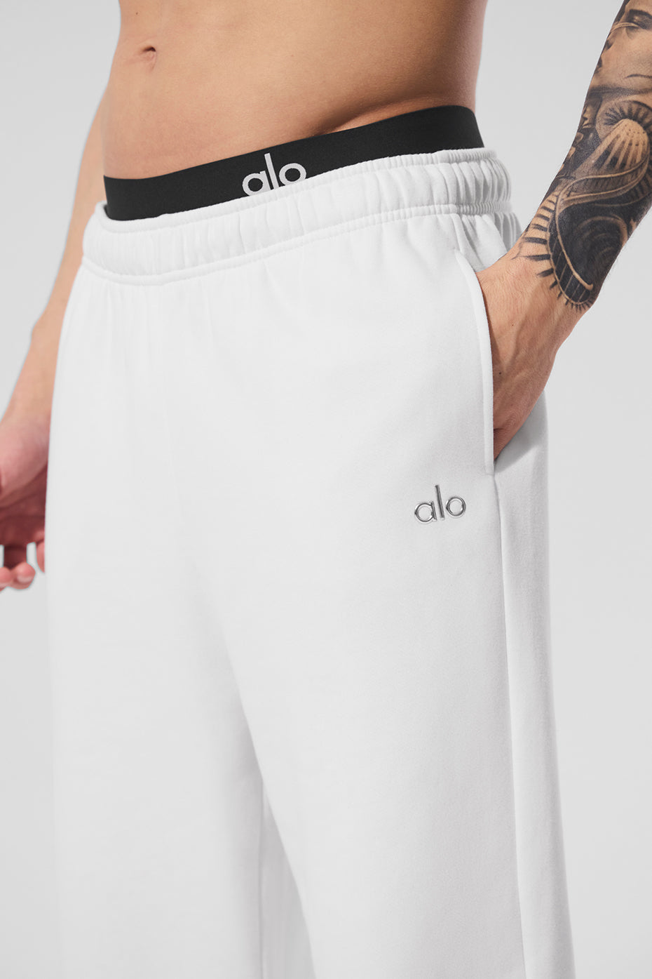 Close-up of white joggers with elastic waistband, perfect for mens loungewear.