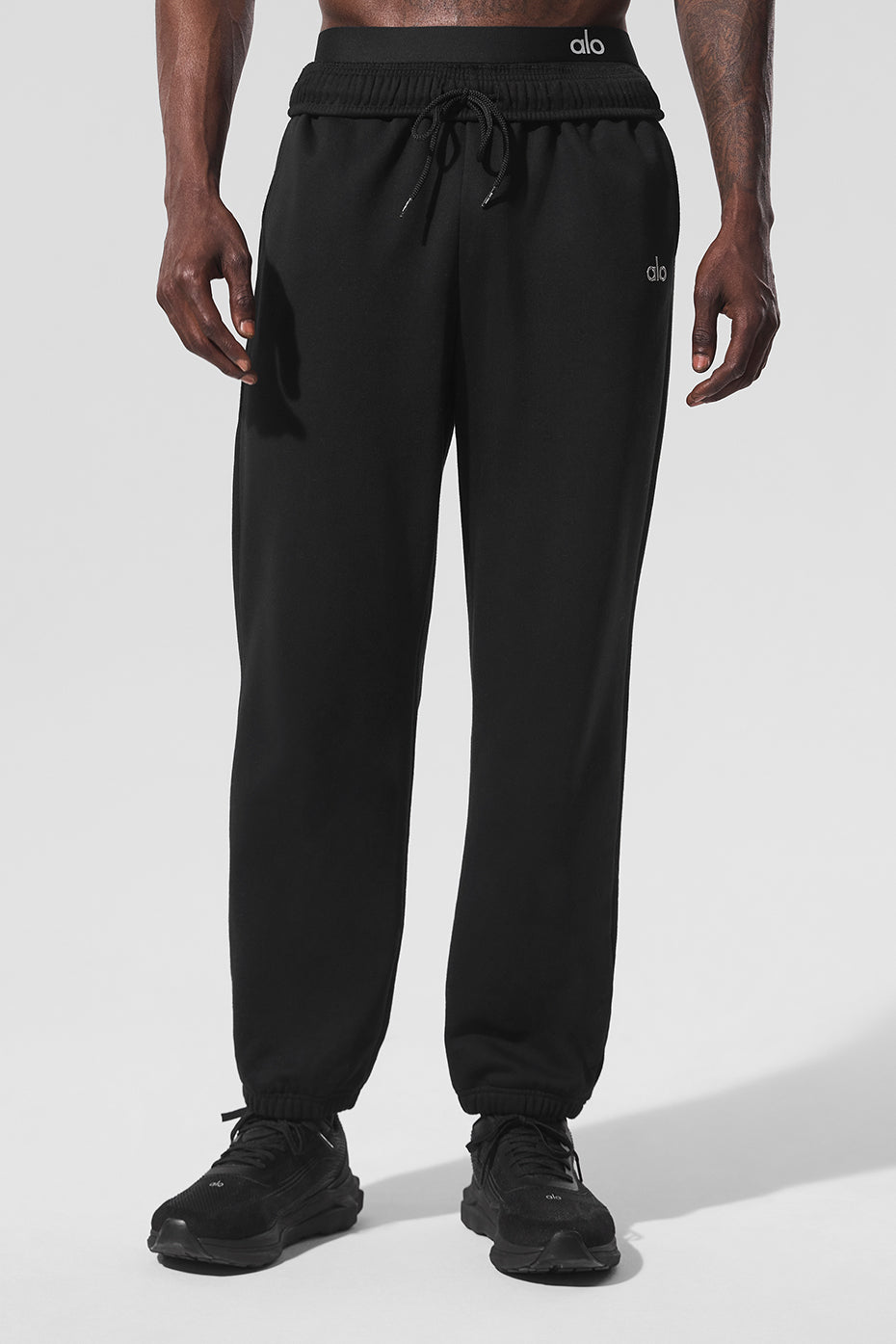 Front view of Accolade black sweatpants, showcasing relaxed fit.