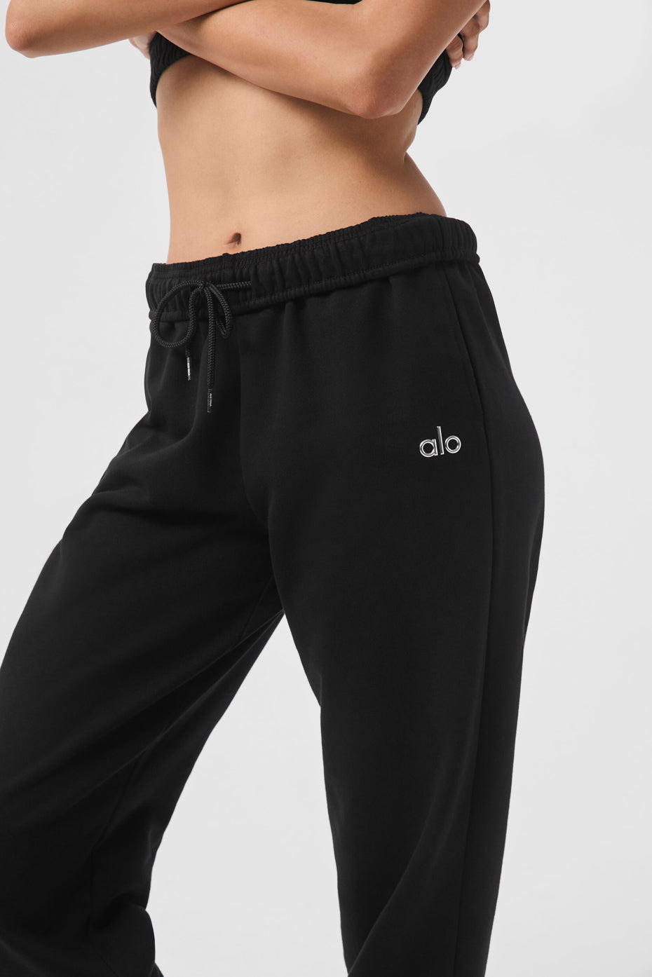 Model pairing black sweatpants with hoodie for street style look