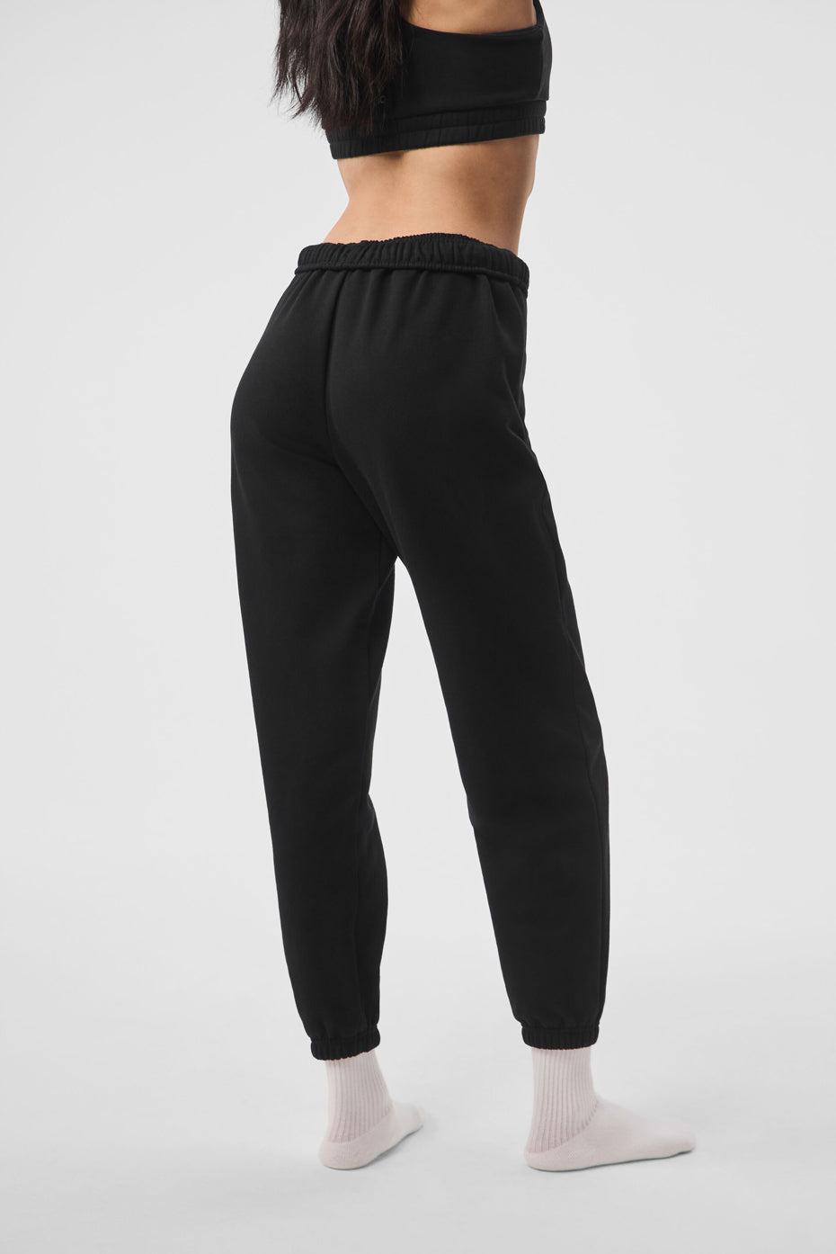 Front view of black sweatpants with relaxed fit, perfect for athleisure wear