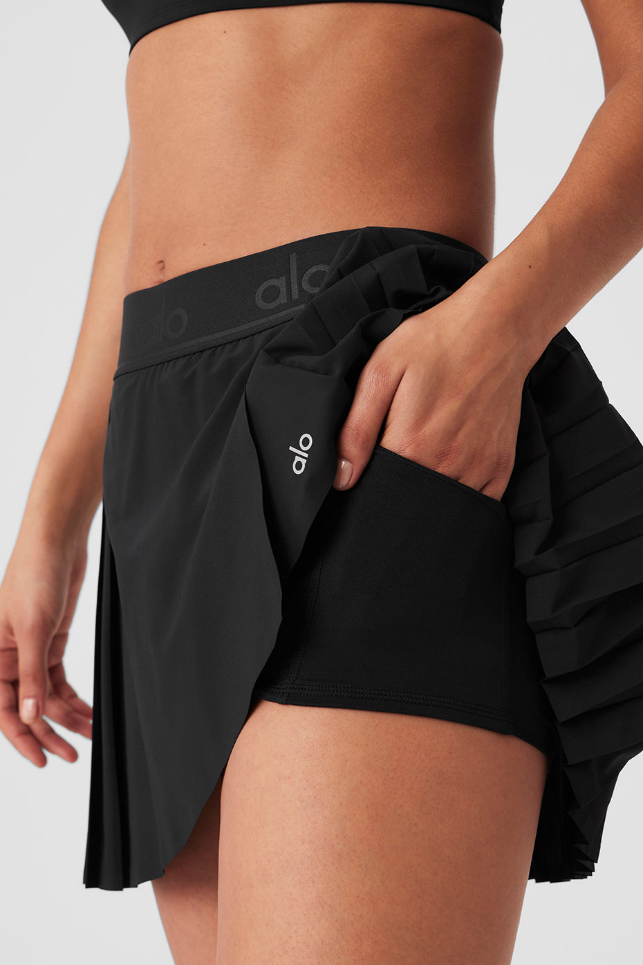 Close-up of hidden pocket in black tennis skirt