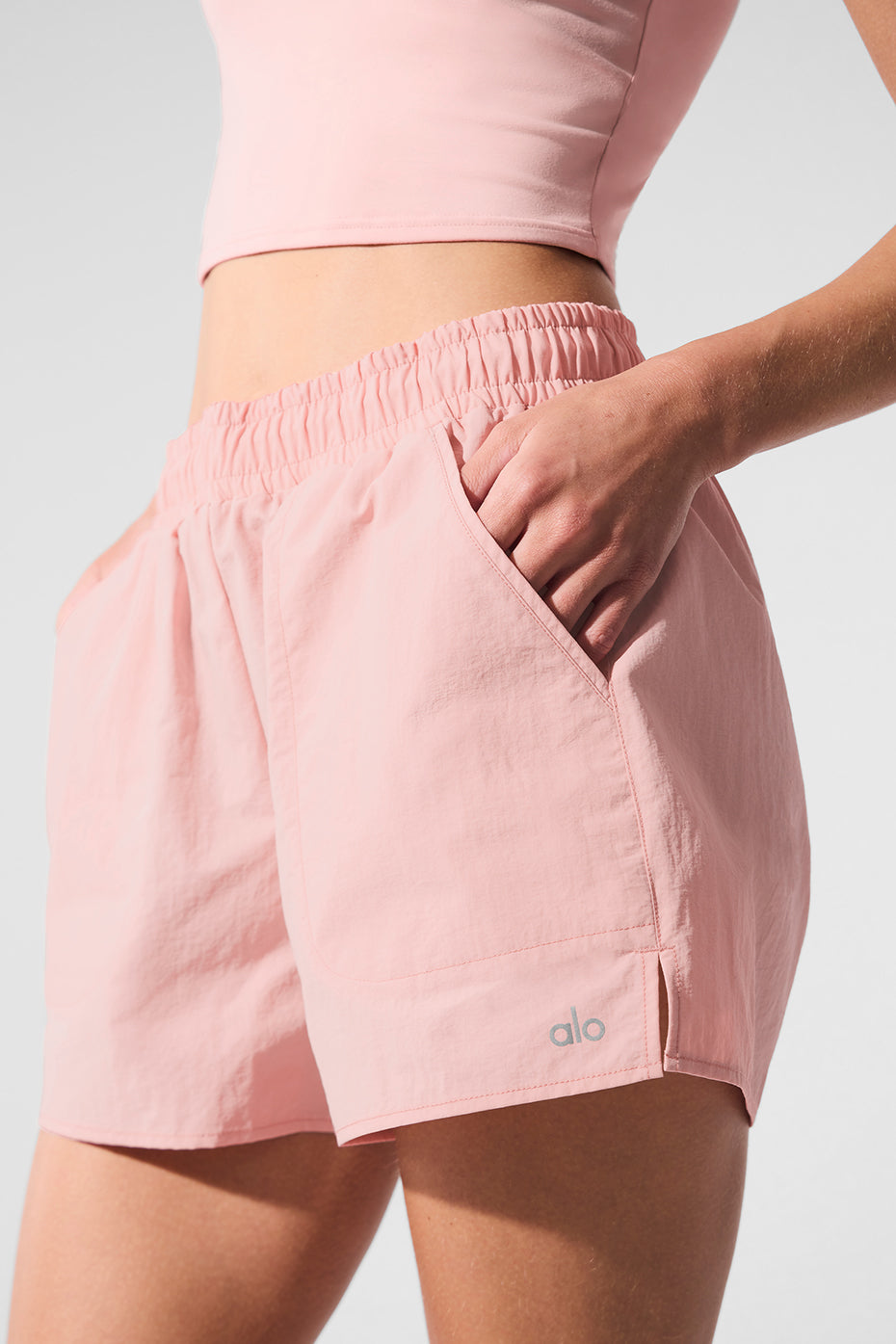 Front view of light pink workout shorts with pockets.