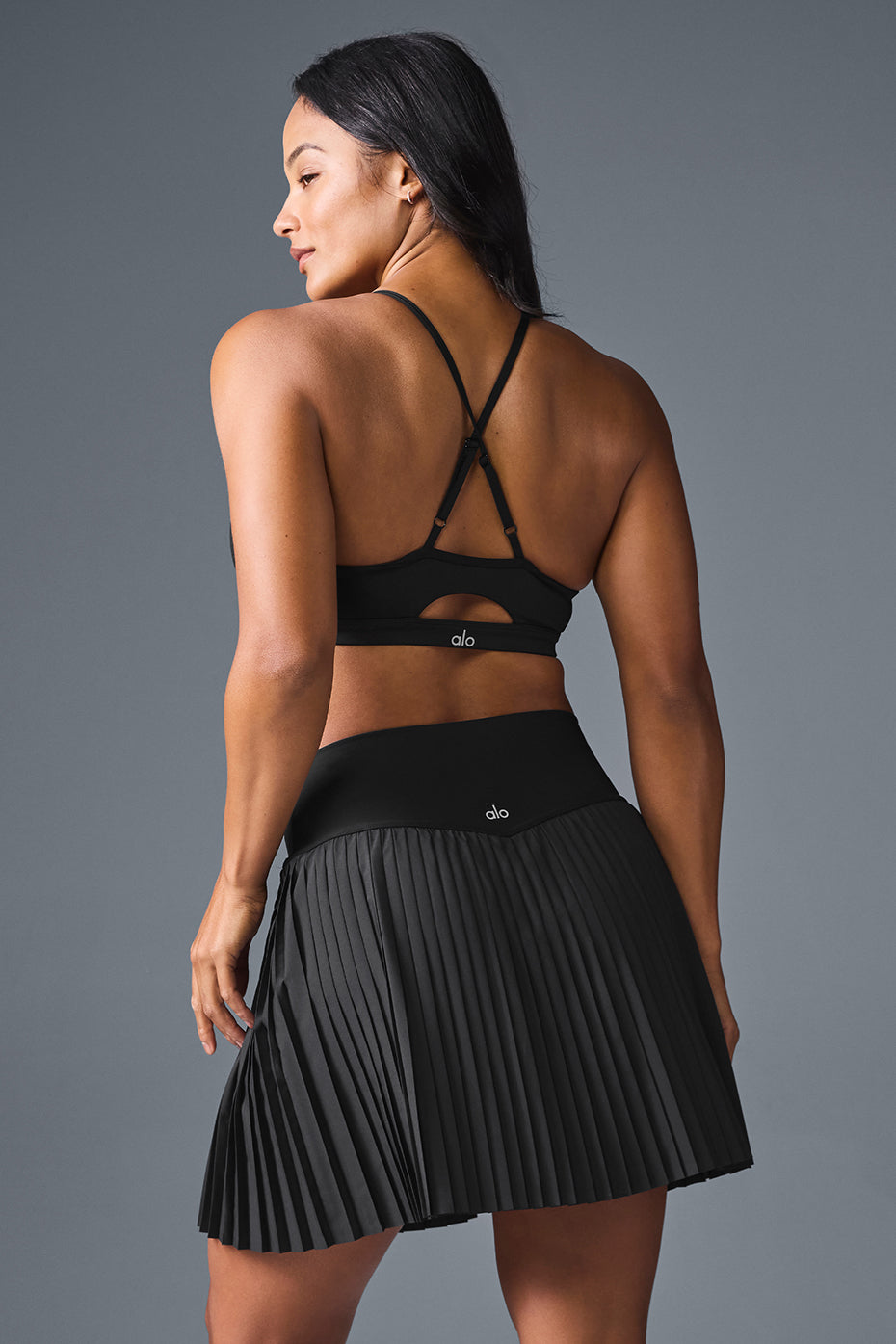 Side view of the Grand Slam pleated tennis skirt in action.