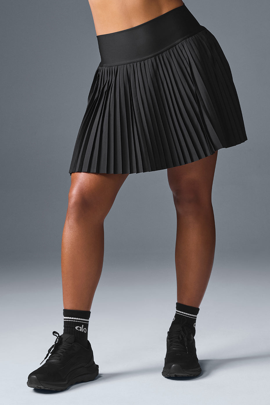 Close-up of the high-rise waistband of the black tennis skirt.