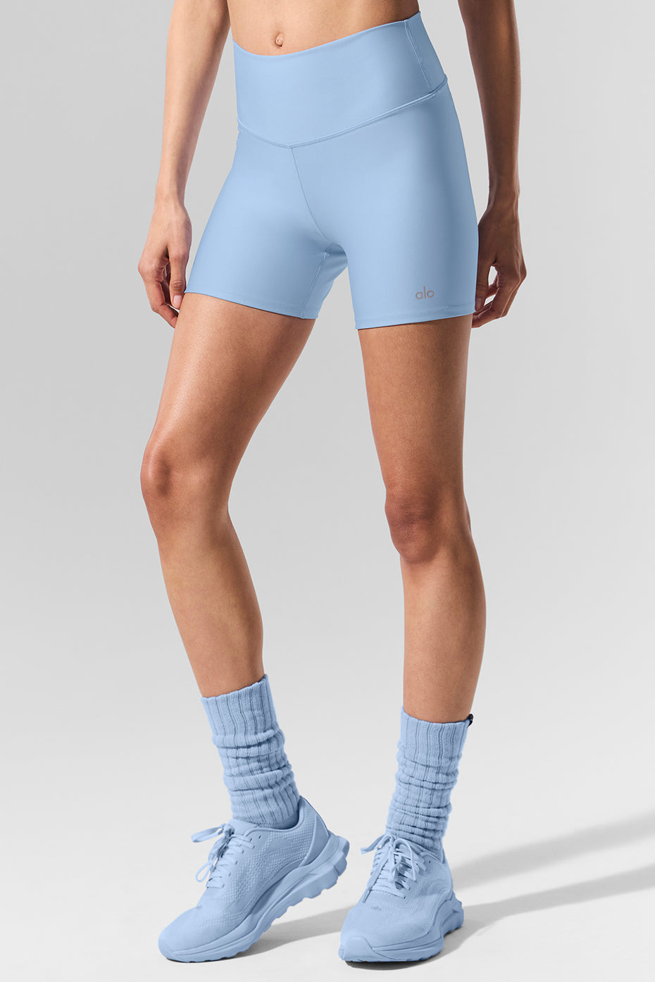 Front view of seashell blue high-rise compression shorts on model