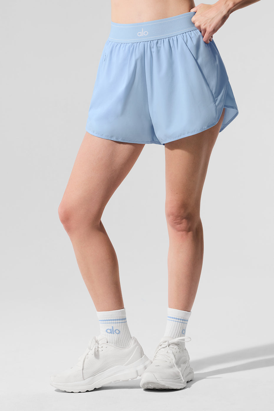 Front view of seashell blue performance running shorts on a model in a running pose.