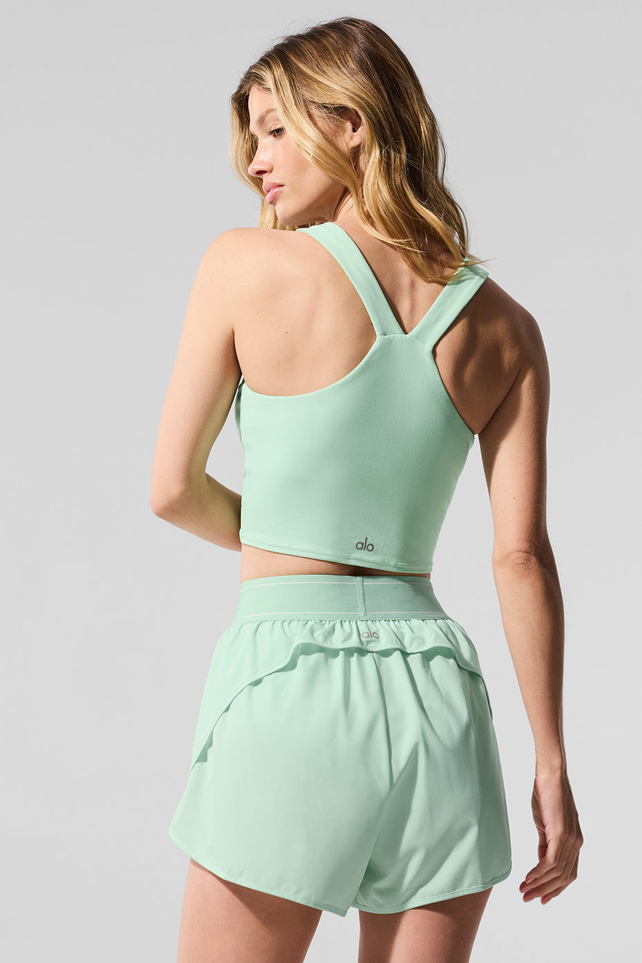 Side view of lightweight spearmint performance shorts with elastic waistband