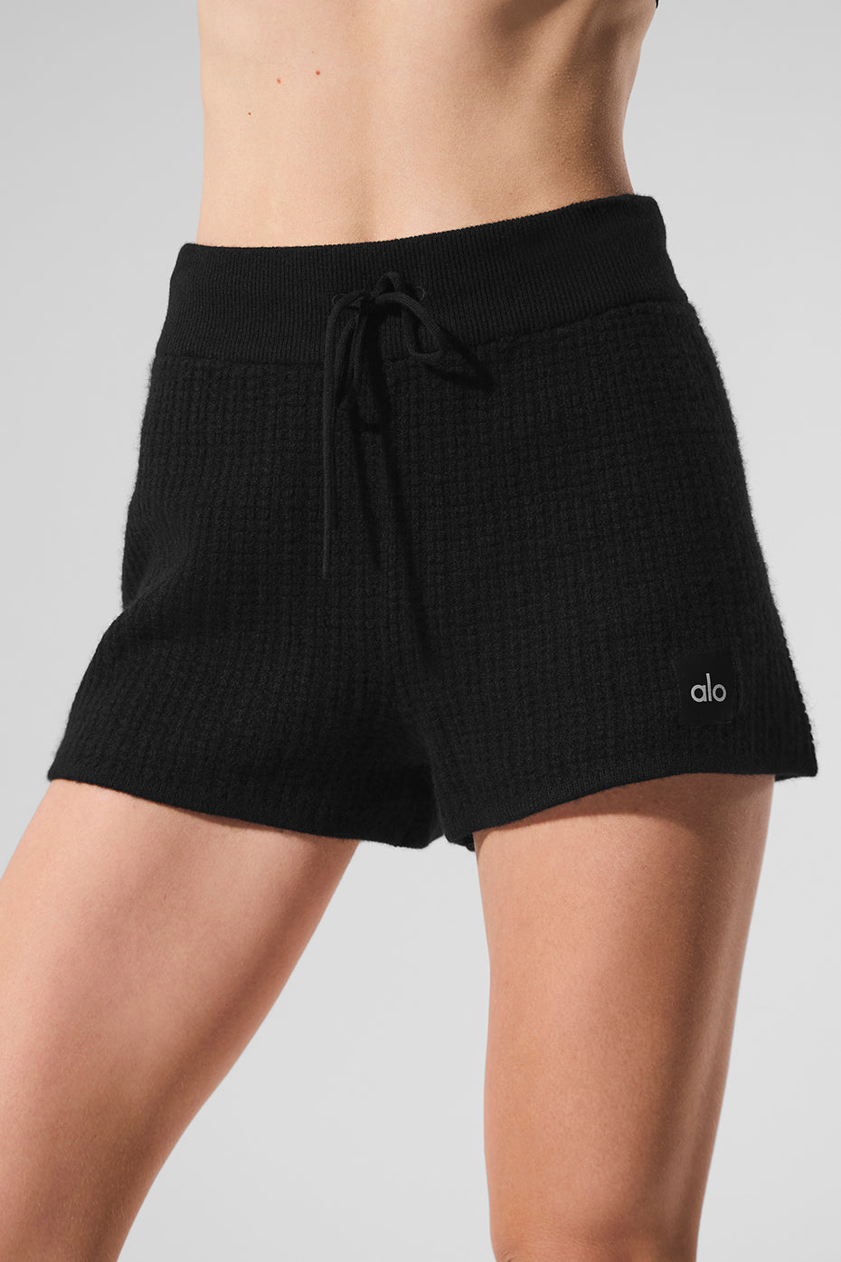 Model wearing plush cashmere shorts paired with a matching short sleeve cashmere sweater