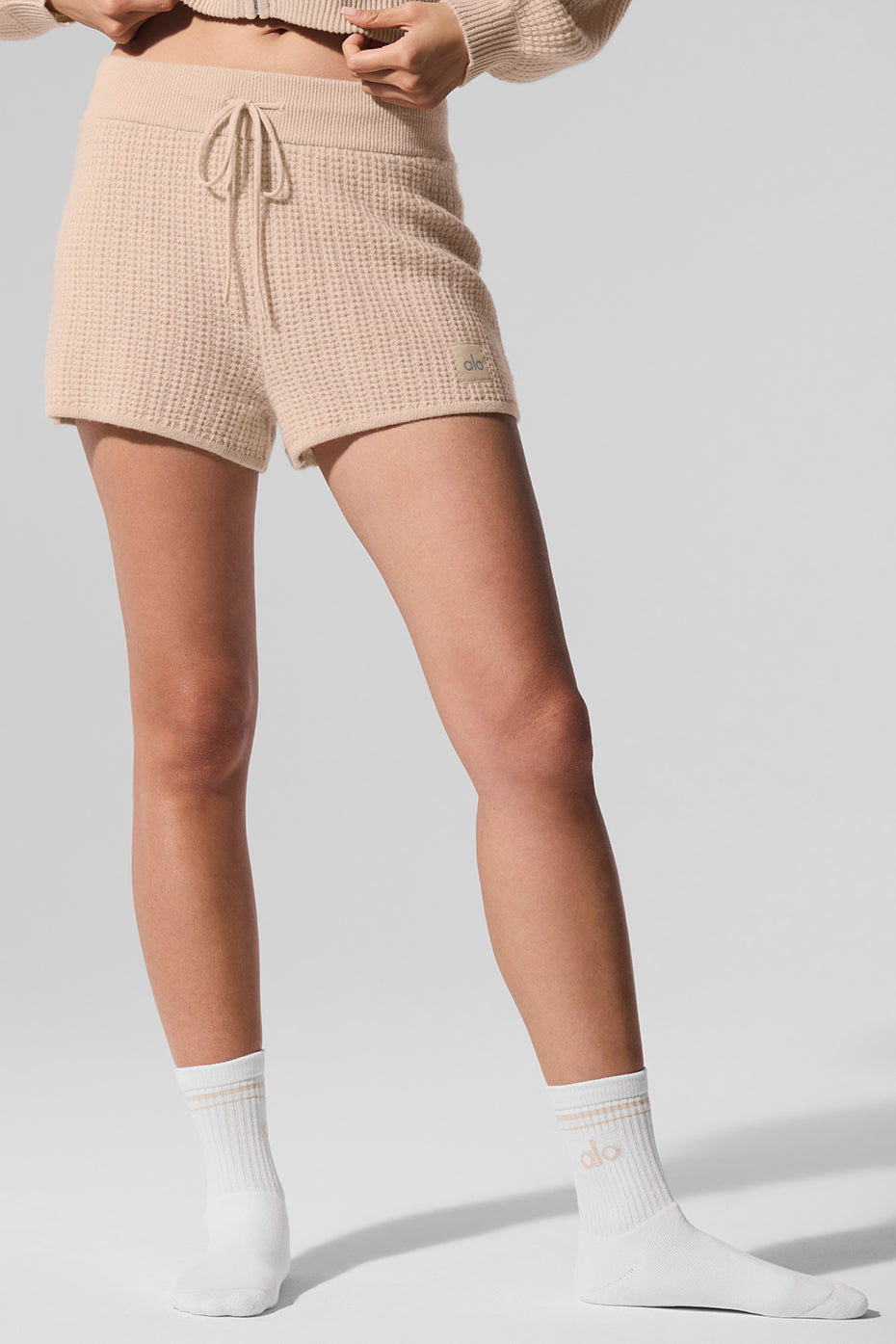 Luxury cashmere high-waist waffle shorts in macadamia blush, perfect for casual outings.