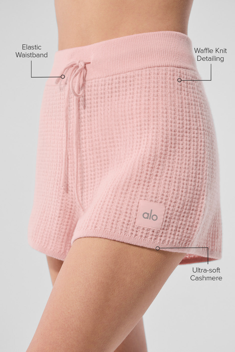 Close-up detail of the breathable knit fabric of high-waisted shorts