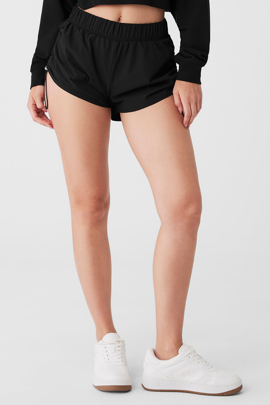 Men's adjustable waist shorts in black, side view showing bungee detail