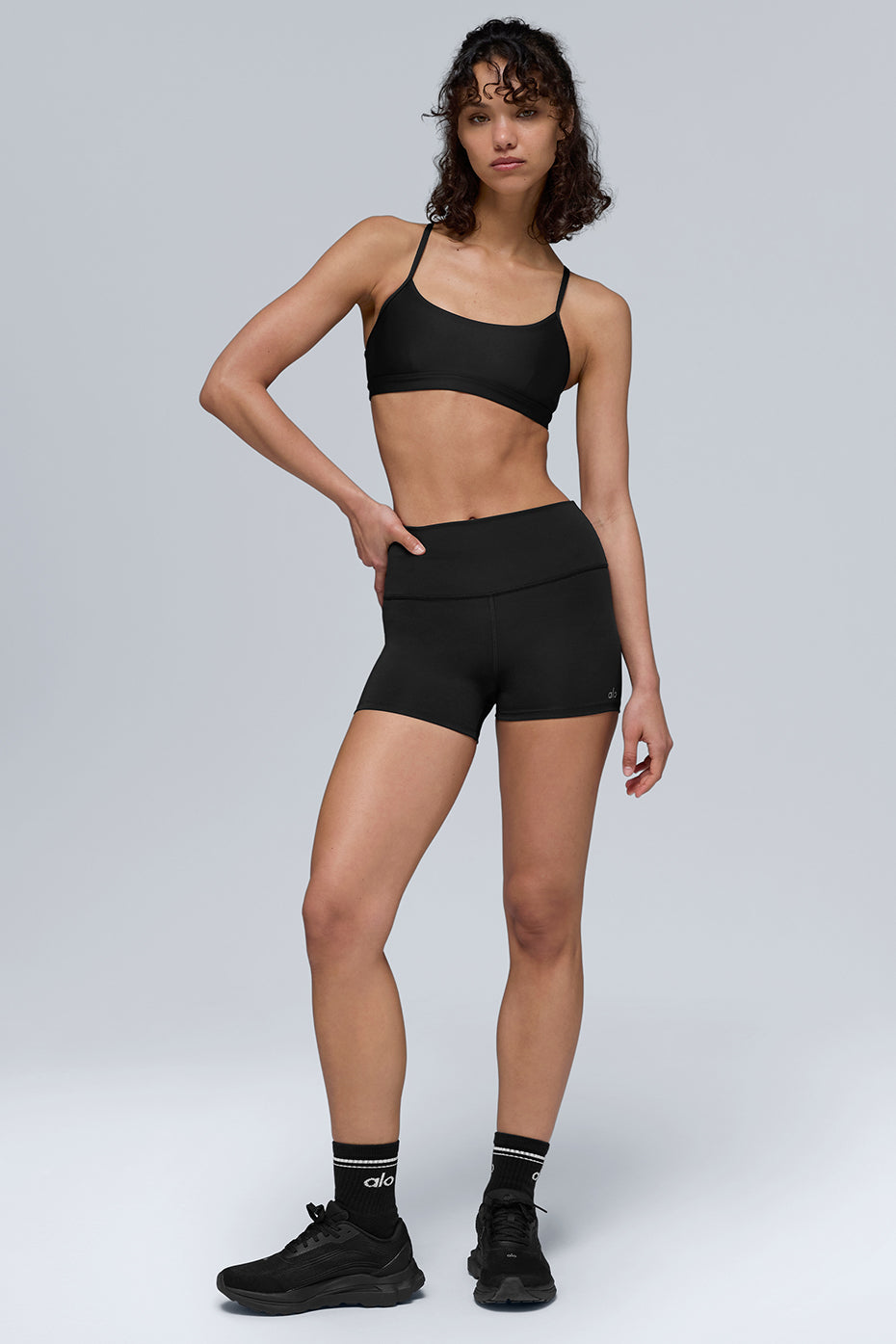 Woman wearing Airlift Energy Short in yoga studio, highlighting no-roll waistband