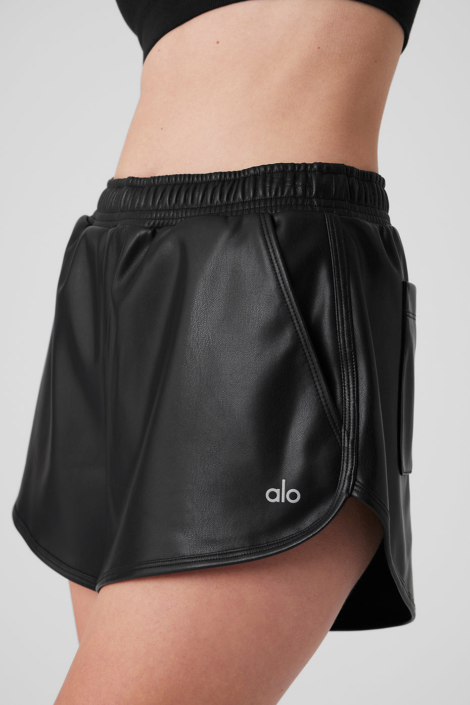 Women’s faux leather shorts with curved hem and elastic waistband, styled with a casual top