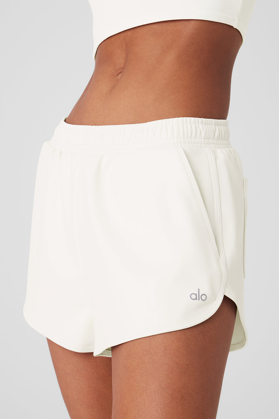 Front view of ivory faux leather high-waisted shorts on a model.
