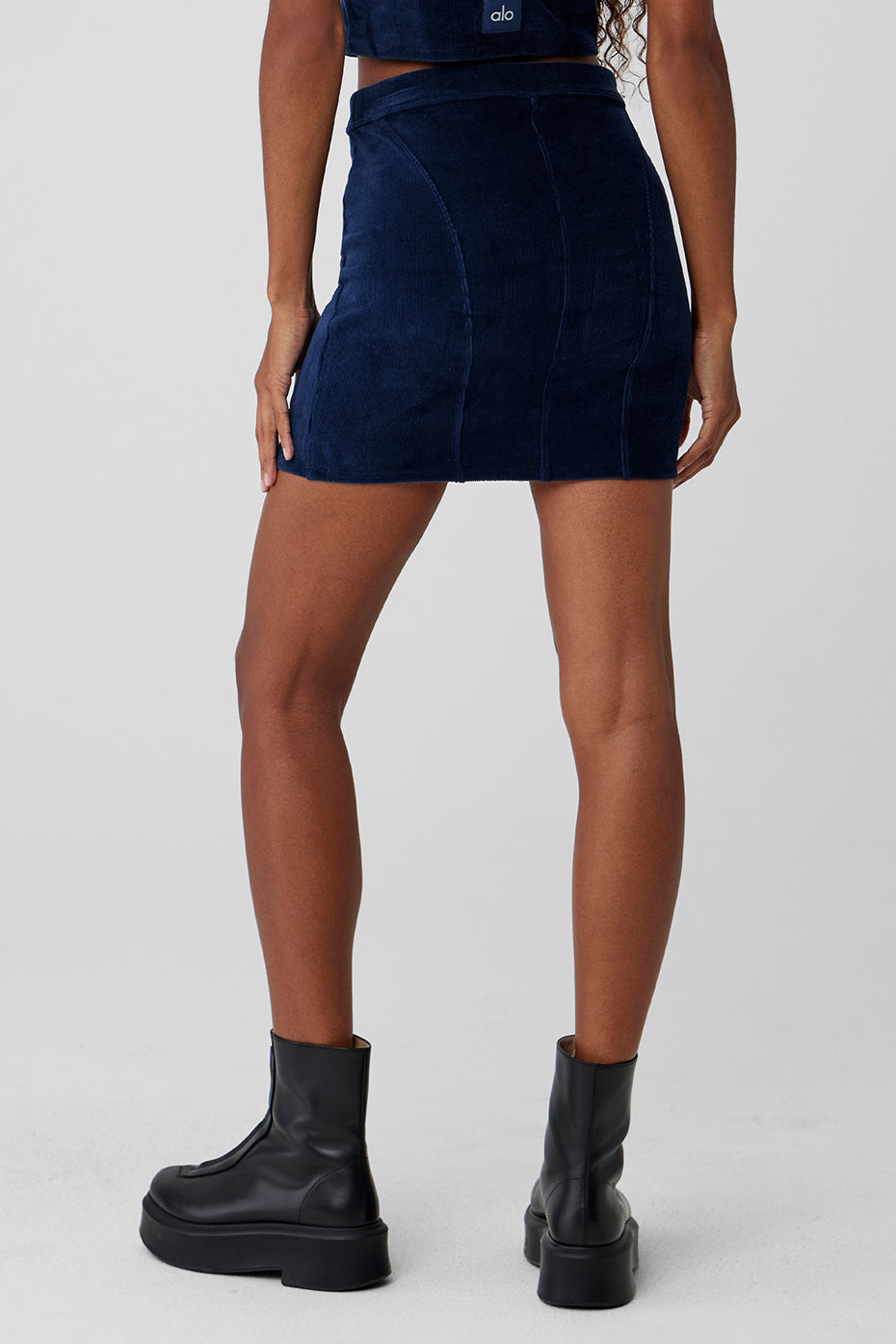 Detail shot of high-waisted corduroy mini skirt with curved seams
