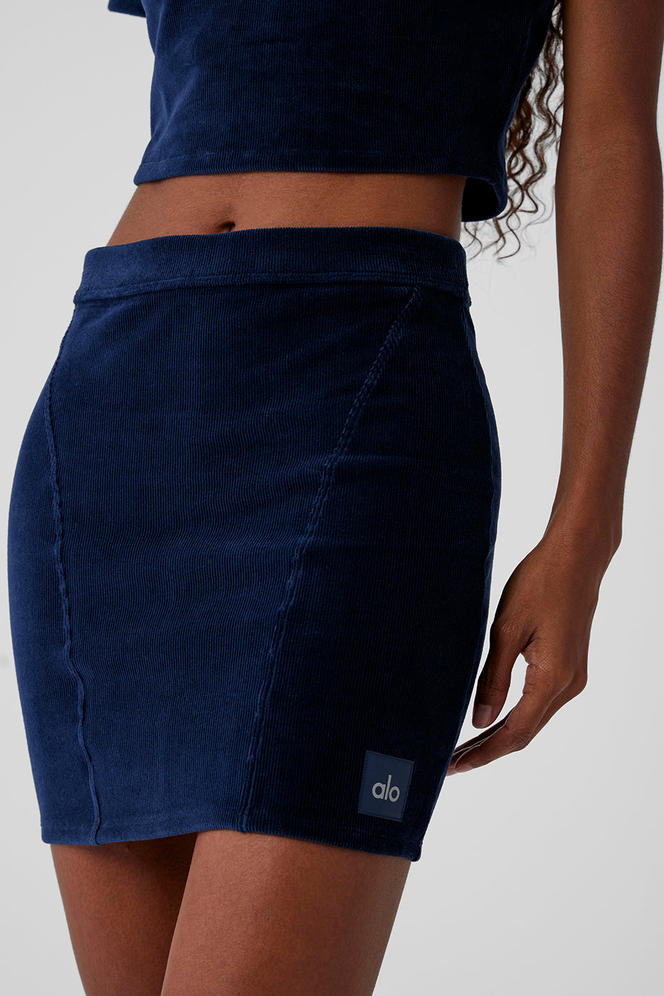 Model wearing navy corduroy mini skirt with a cozy sweater for winter style