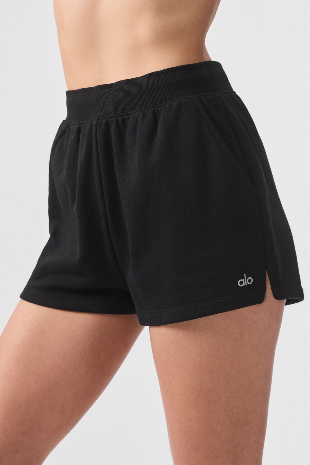 Mens sweat shorts styled casually with white sneakers for street-ready look