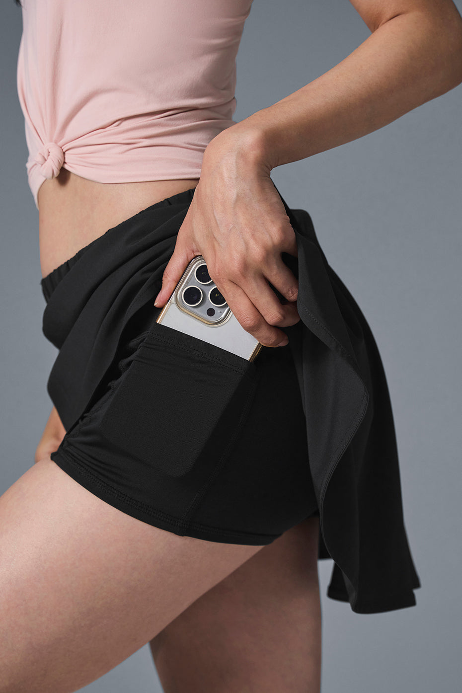 Flat lay of black pencil skirt with visible pocket lining and stitching