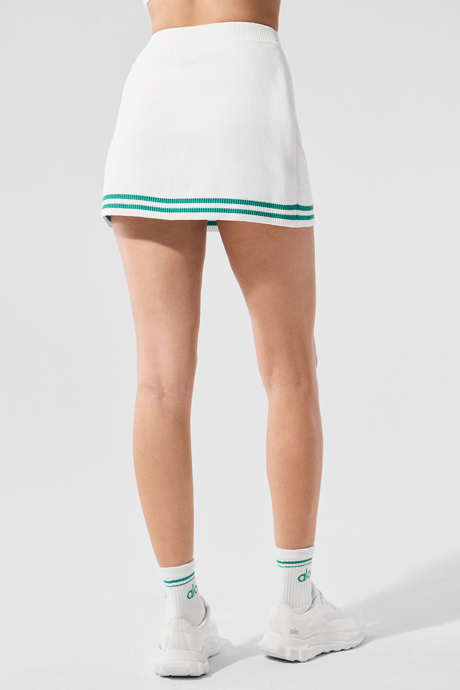 Close-up detail of the collegiate stripes on the skirt.