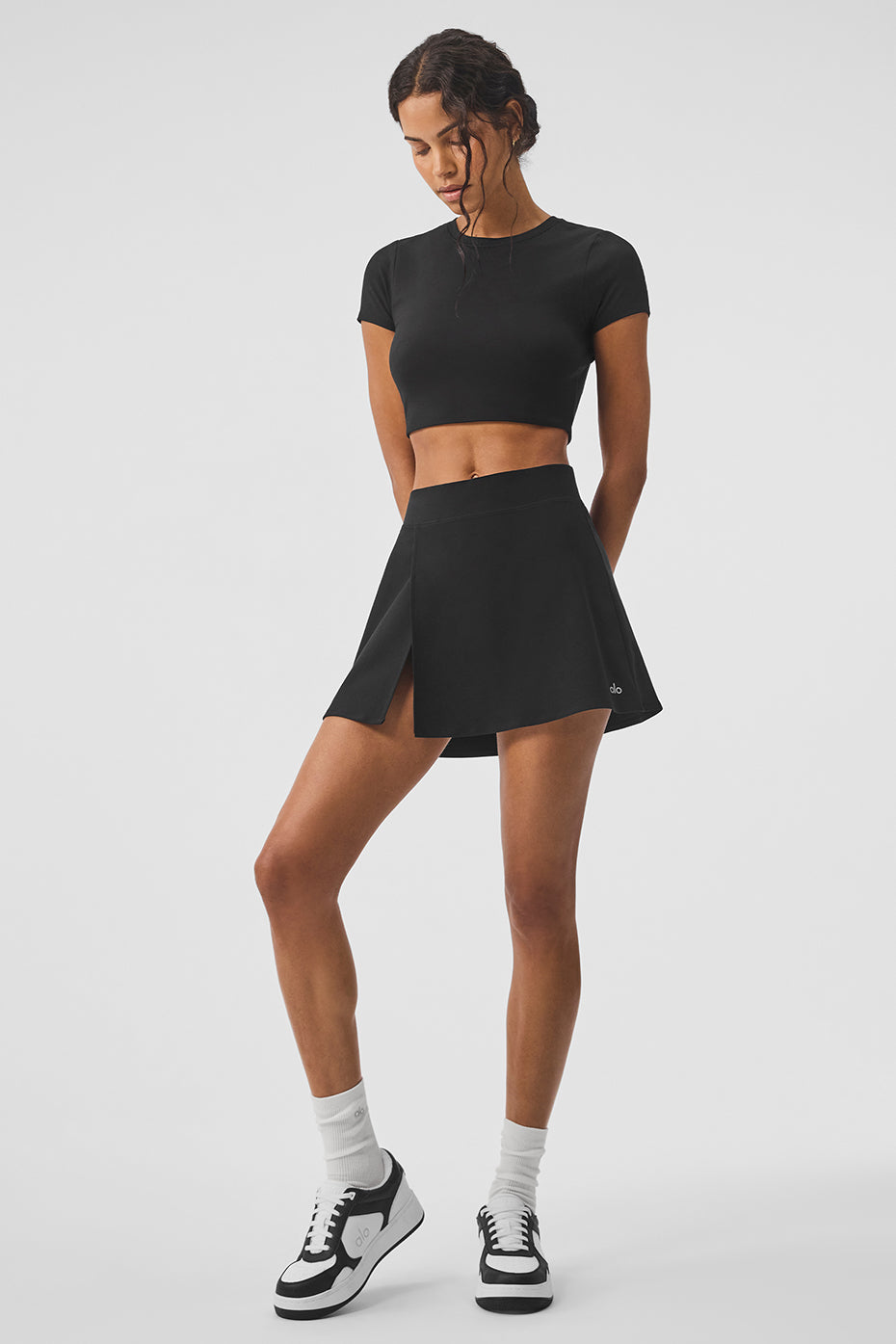 Alo Yoga Backspin Tennis Skirt in black, perfect for tennis and casual wear.