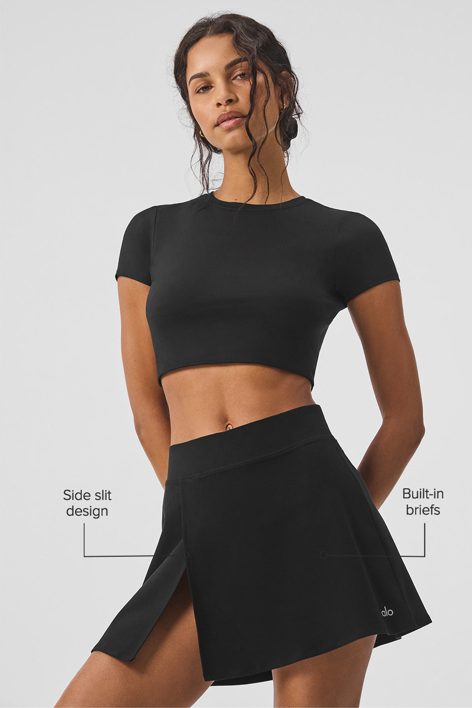 Close-up of the fitted waist and side slit of the Alo Yoga Backspin Skirt.