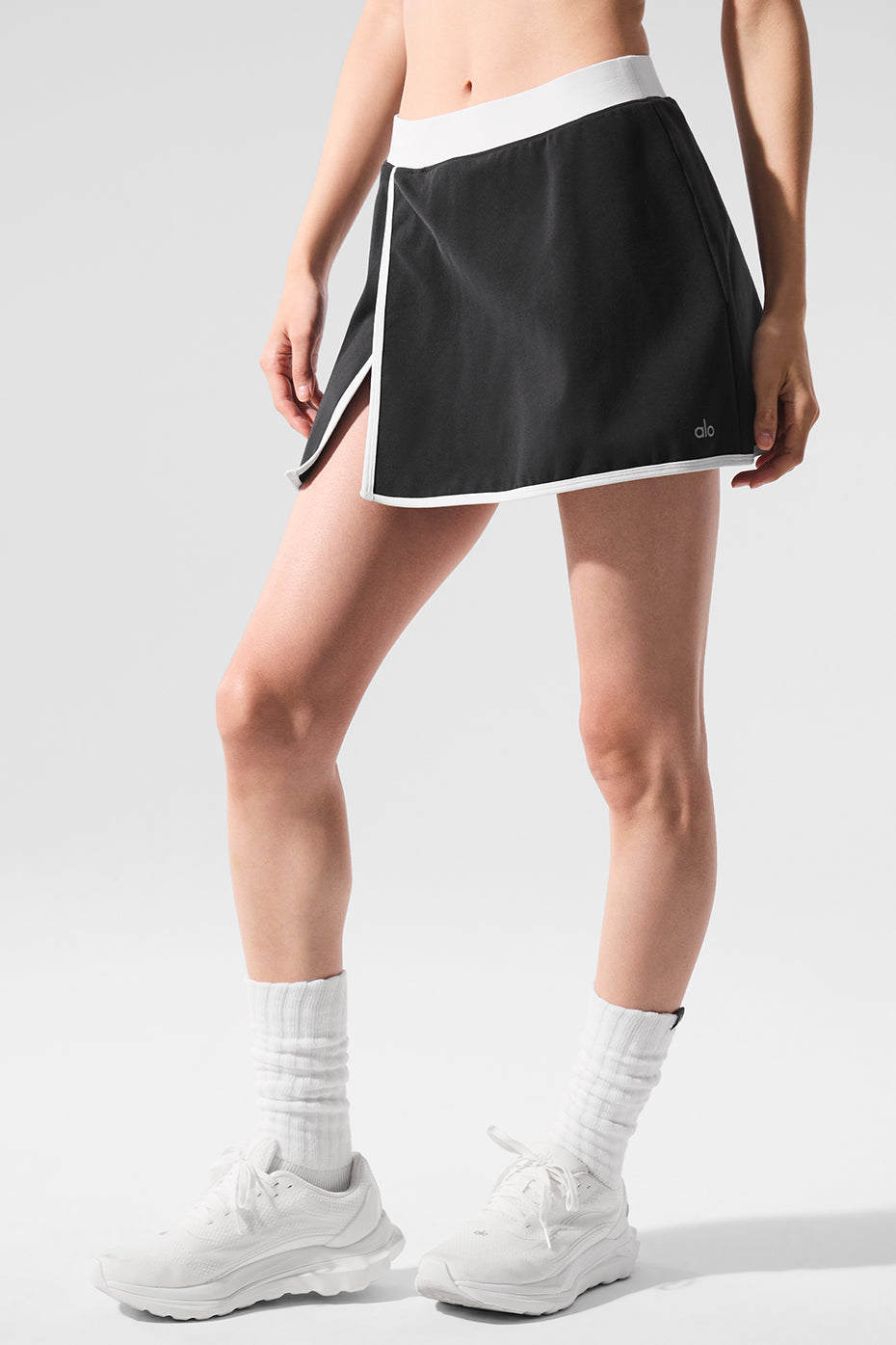 Close-up of black tennis skirt slit detail with contrast stitching