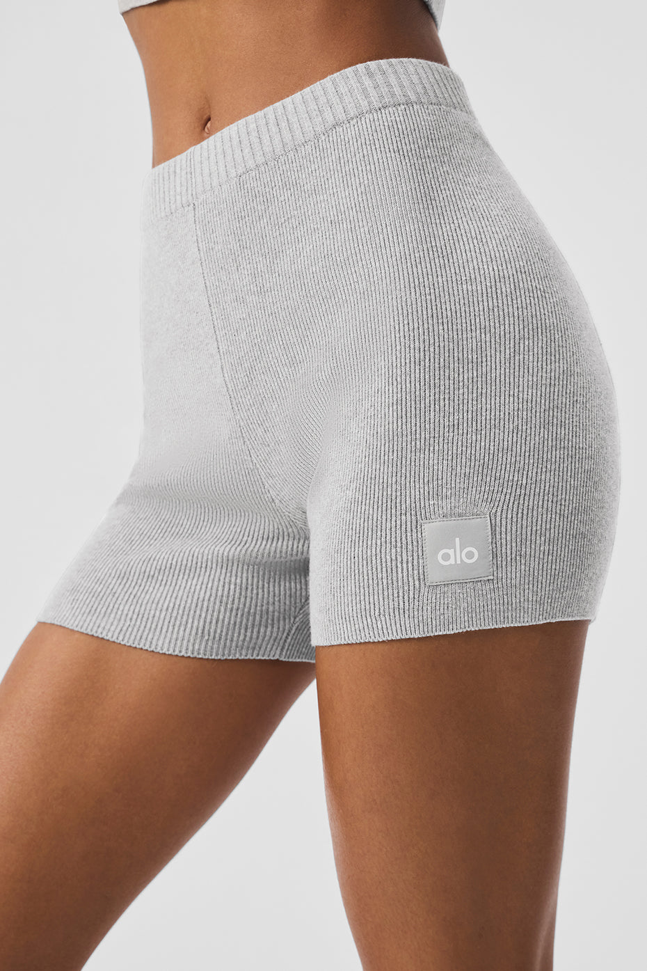 Model wearing cotton knit shorts styled with sneakers and scrunched socks