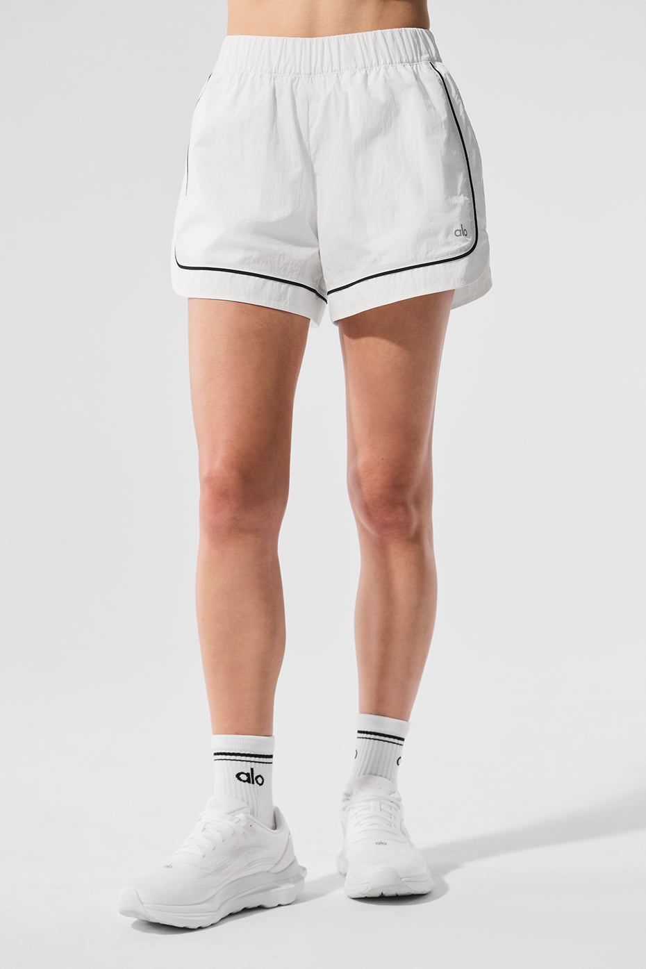 Close-up of Motivate Track Shorts showing contrast piping detail