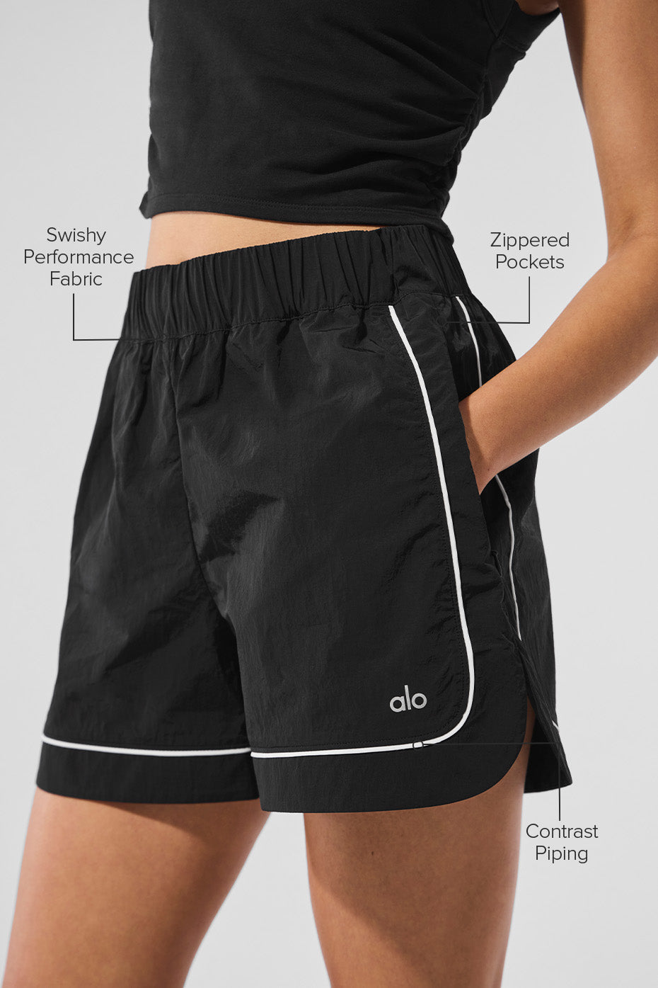 Model wearing performance shorts with zippered pockets for activewear