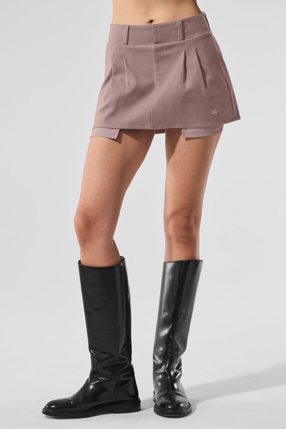 Front view of the mushroom pleated mini skirt styled with a cropped tee.