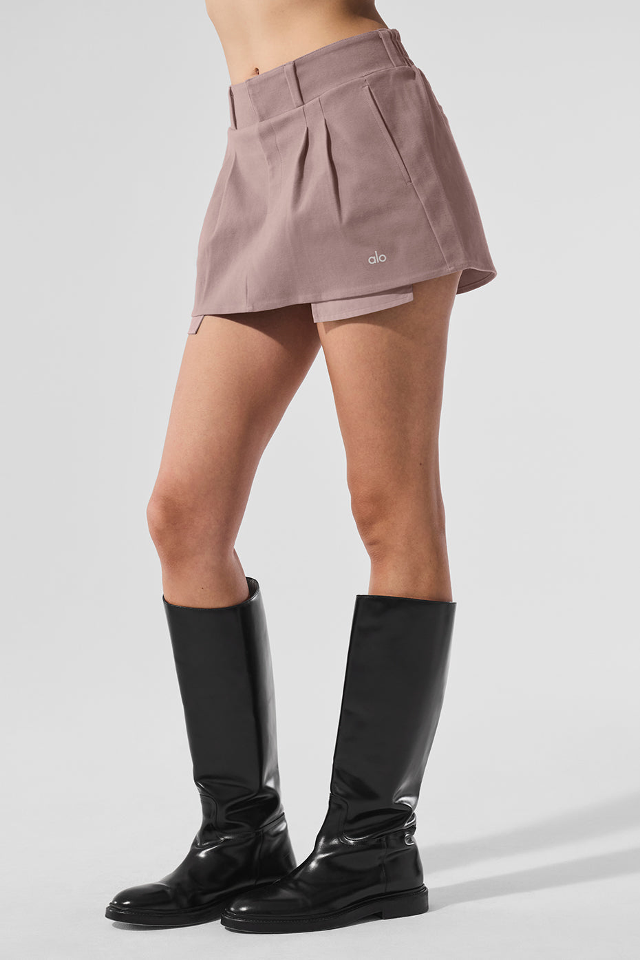Front view of the mushroom pleated mini skirt styled with a cropped tee.