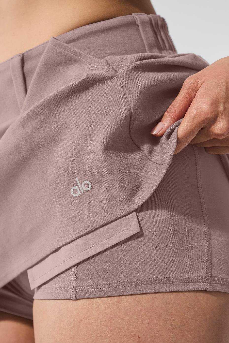 Side angle of the mushroom mini skirt paired with an oversized sweater.