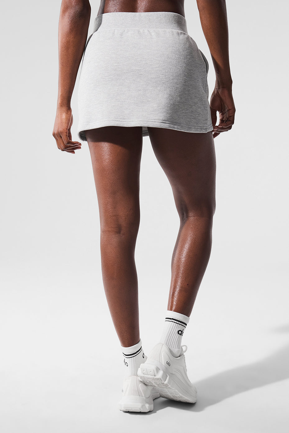 Athleta tennis skirt in heather grey worn on a sunny day at the park.