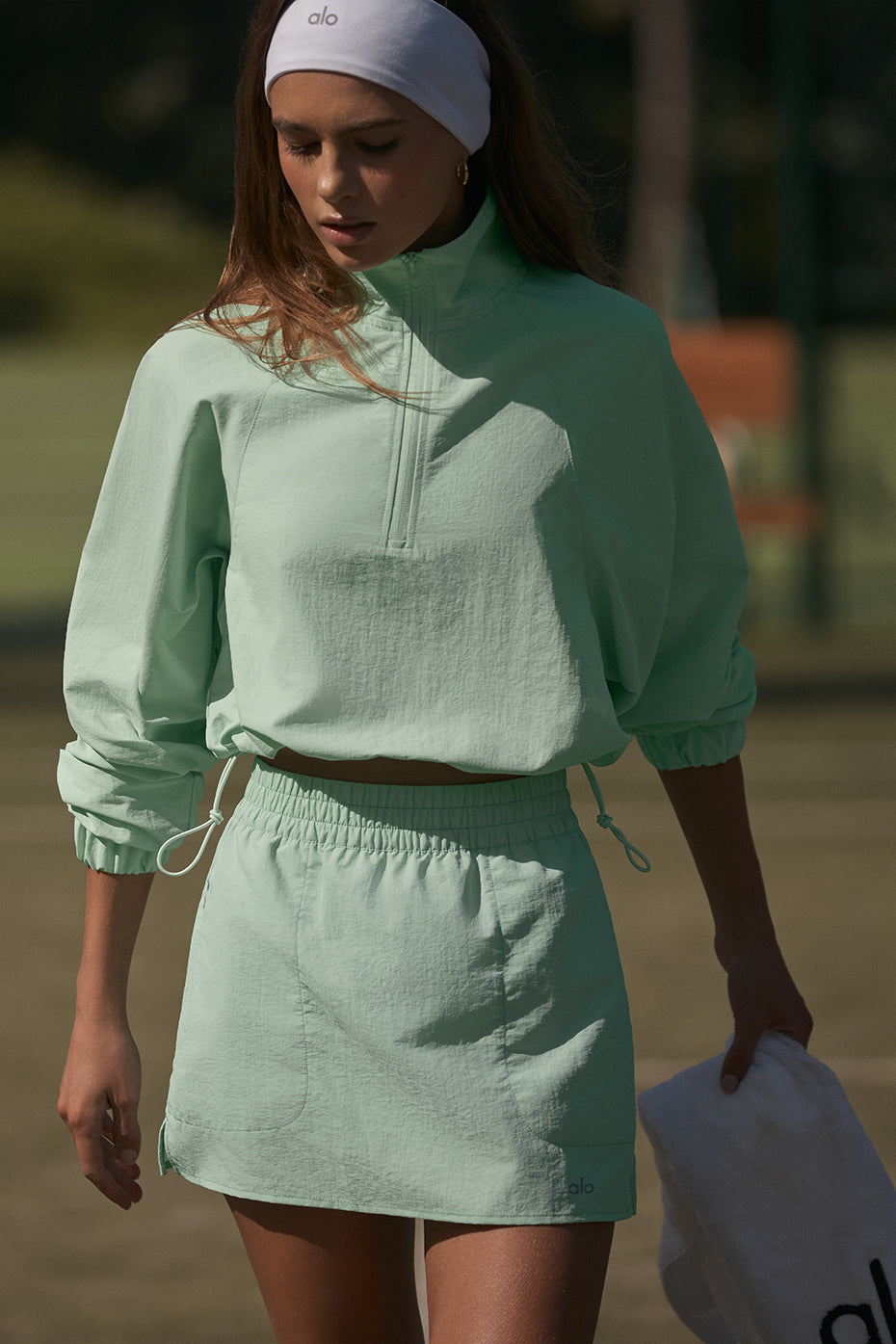 Front view of the spearmint Alumni tennis skirt with built-in shorts.