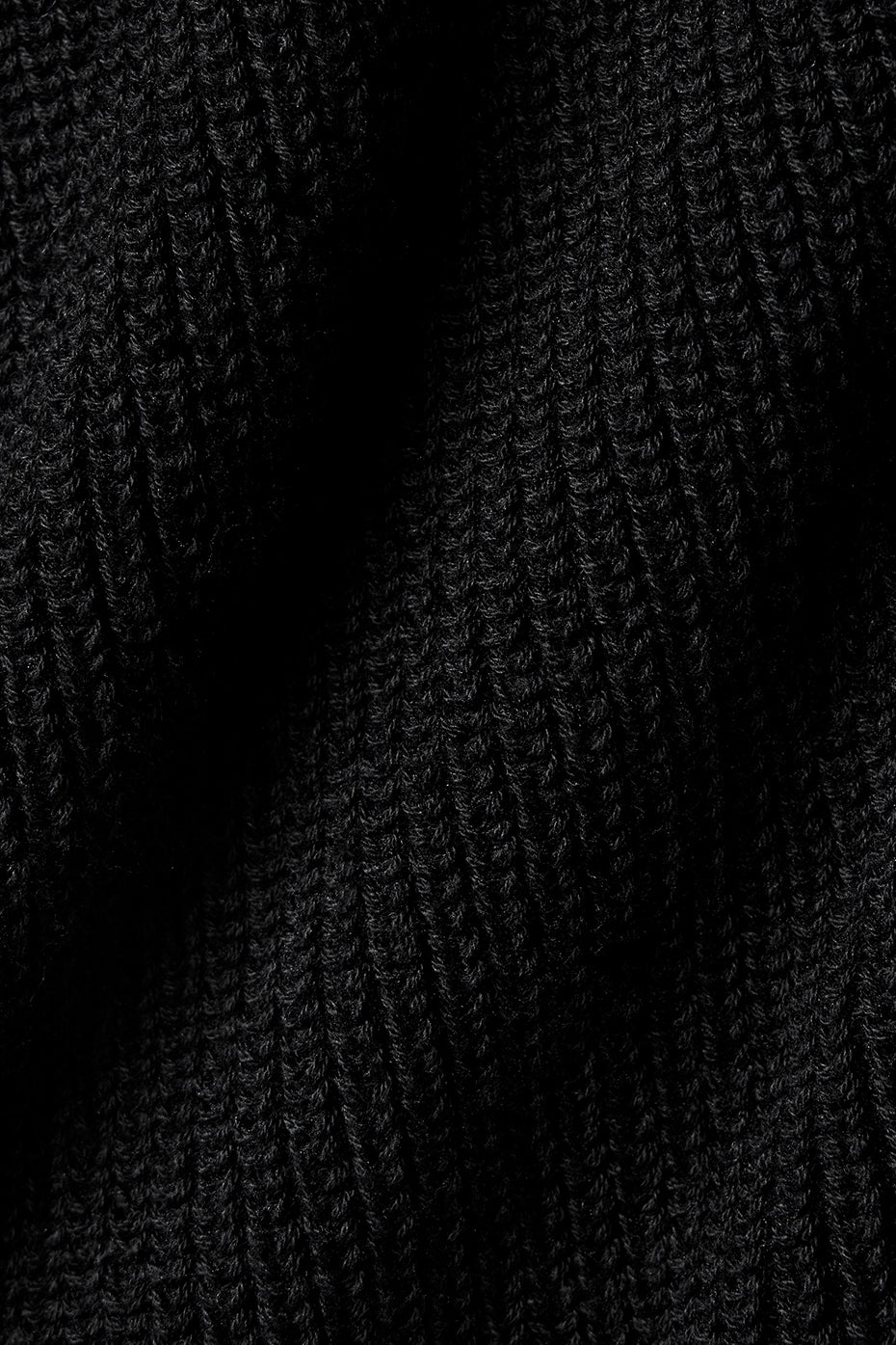 Model wearing black sweater shorts with a casual tank top for loungewear