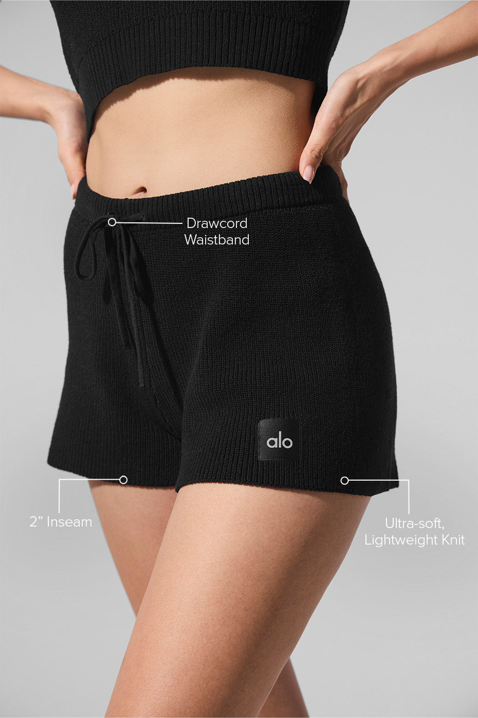 Model wearing black sweater shorts with a casual tank top for loungewear
