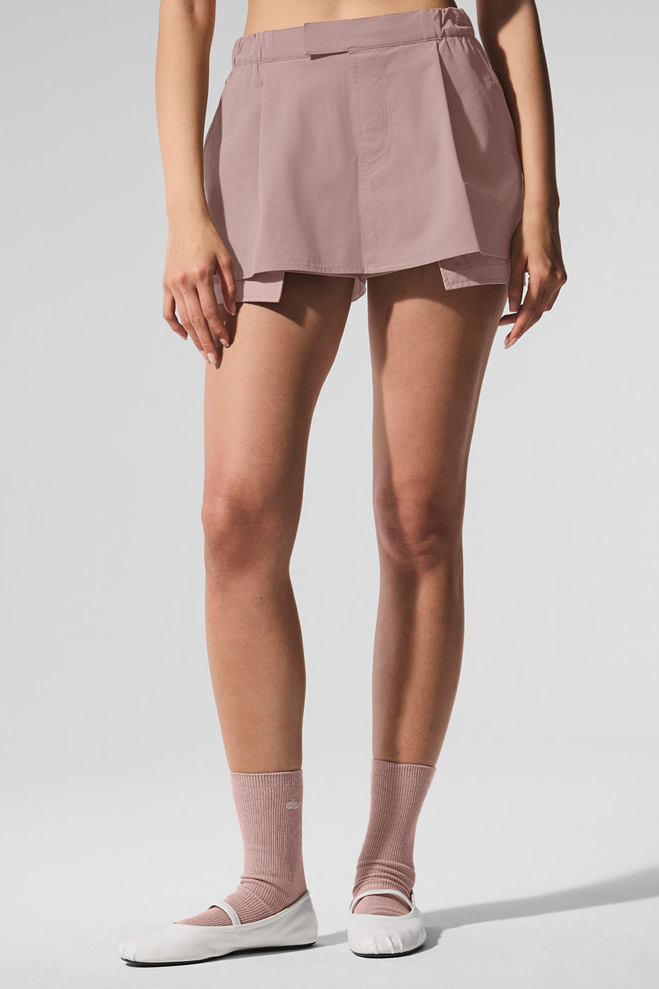 Front view of taupe mini skort worn casually outdoors in Miami sun